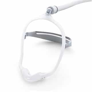 Philips Respironics Dreamwear nasal cradle mask for CPAP therapy with a white cushion and gray frame, designed to be worn under the nose.