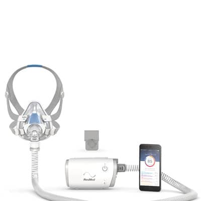 AirMini connected to F20 Mask through AirMini tubing, with a smartphone displaying the integrated AirMini app next to the device.